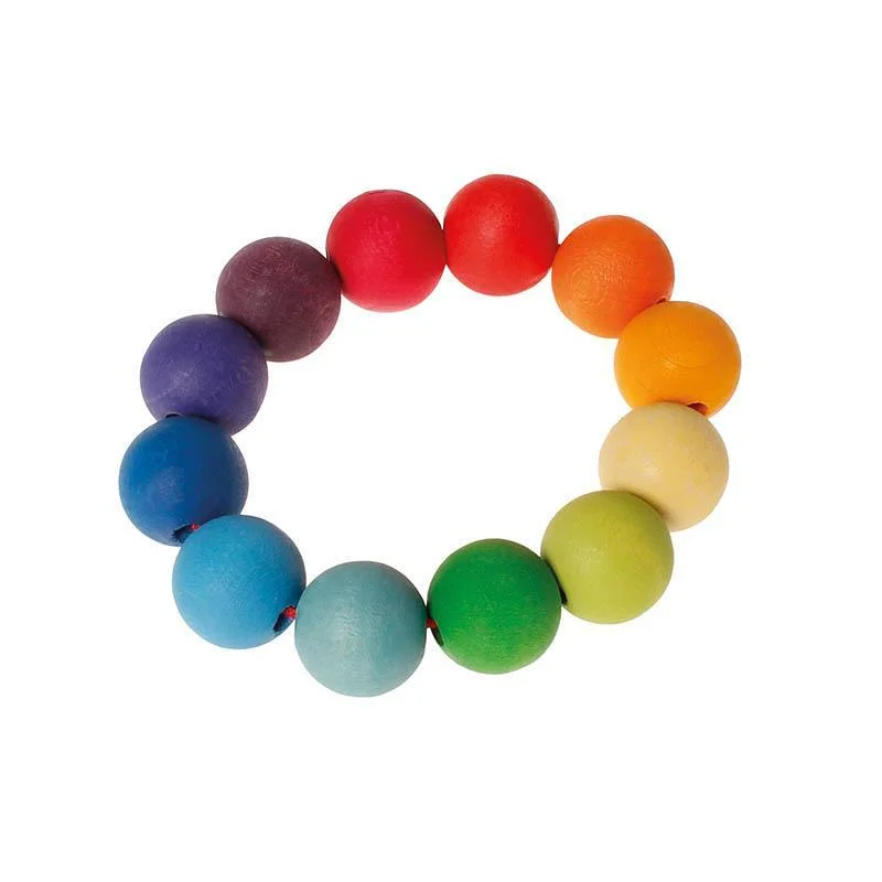vibrant and colorful wooden toys for toddlers                   Grimm's grasping bead ring toy